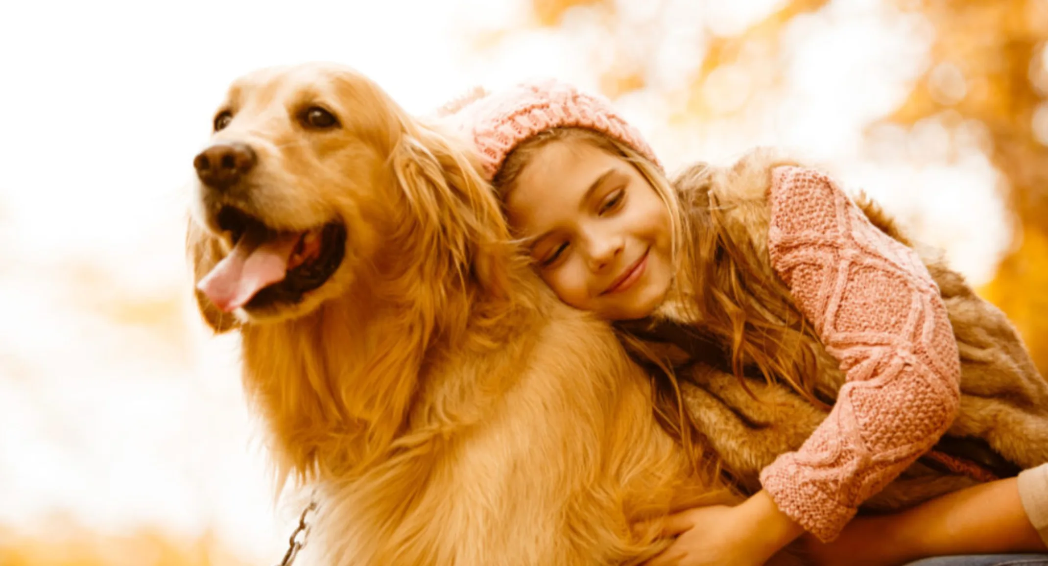 Girl Hugging Golden Retriever